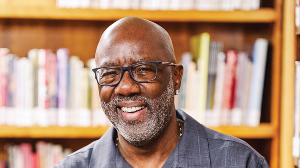 photo of Reverend Doctor Don Davis holding a book and smiling