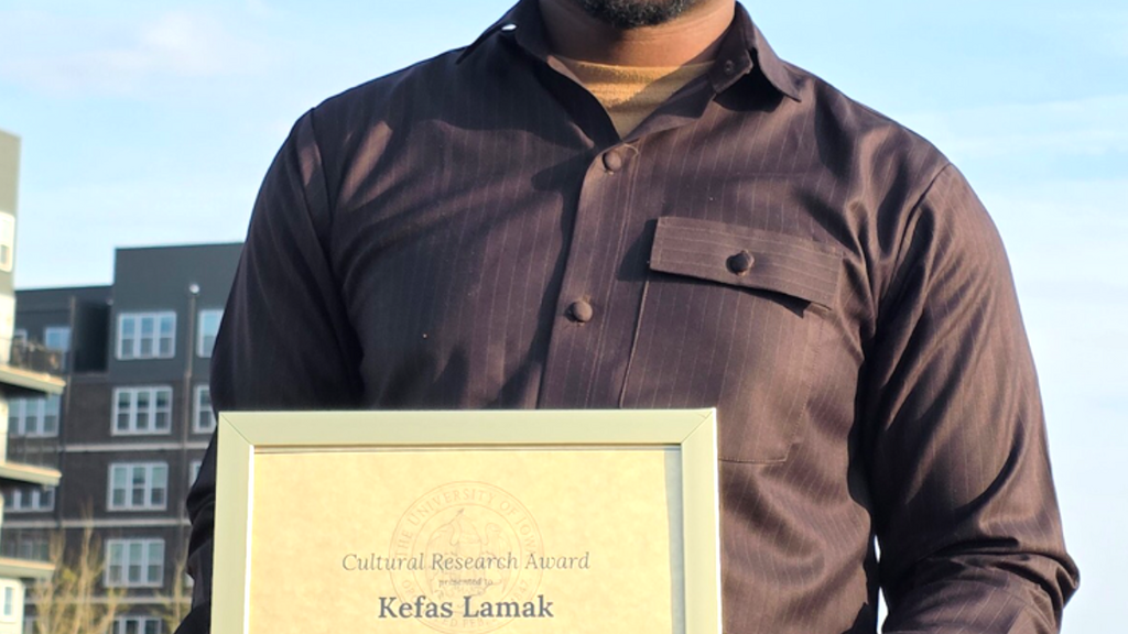 Kefas with his award certificate